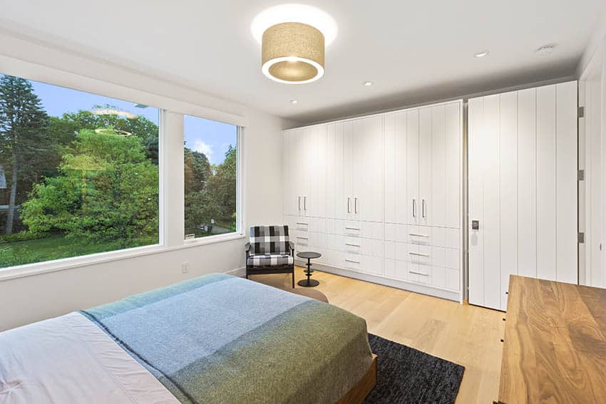 Drum light with fabric shade and white built in cabinets