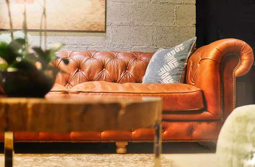 Brown leather sofa against concrete wall