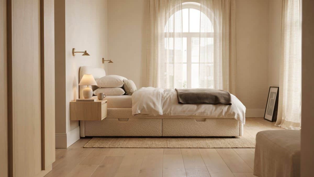 Contemporary oak storage platform bed with base drawers under an arched window