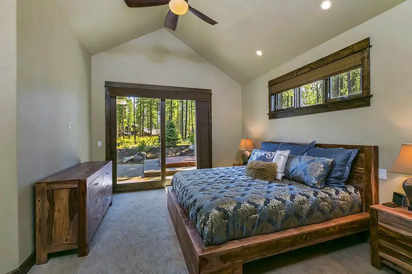 Craftsman master bedroom with sliding door to patio with hot tub