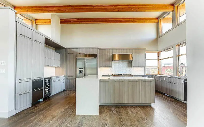 Dream kitchen with wood veneer cabinets quartz island open wood beams