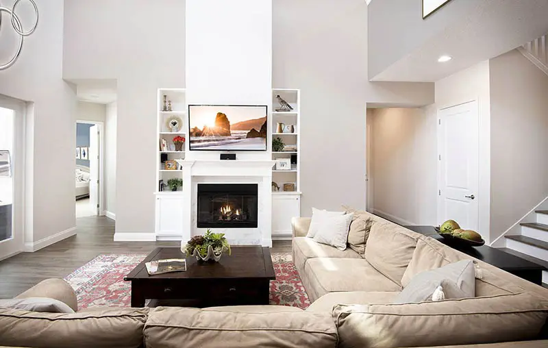 Great room with high ceiling fireplace with hearth sectional sofa