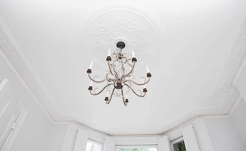 Hanging chandelier on white ceiling