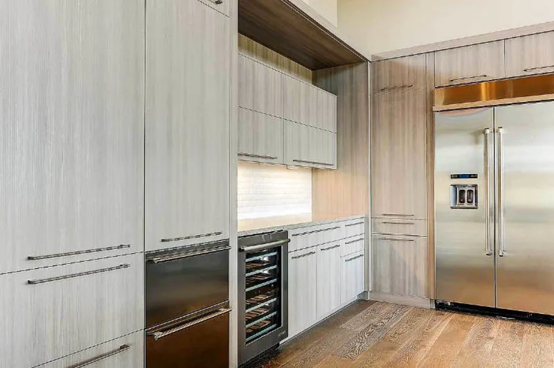 High kitchen cabinets with built in freezer and wine refrigerator