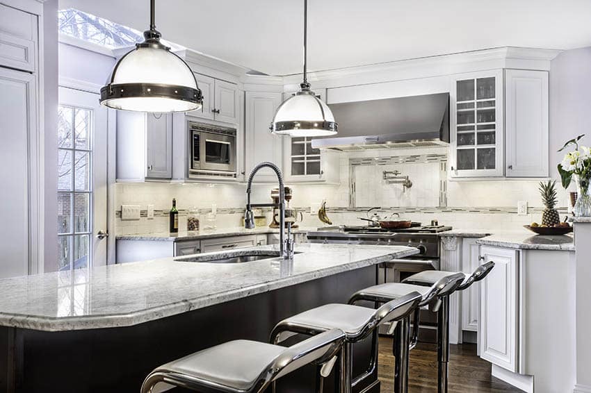 Kitchen island with metal pendants and chrome stools