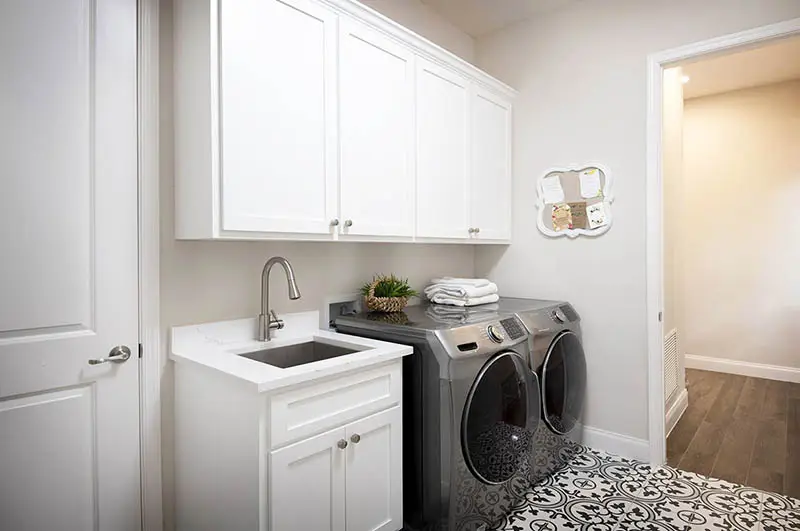 Laundry room with built in cabinet storage