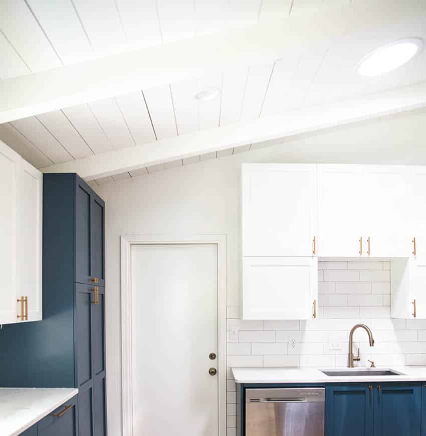 Modern farmhouse kitchen with shiplap ceiling two tone white blue cabinets