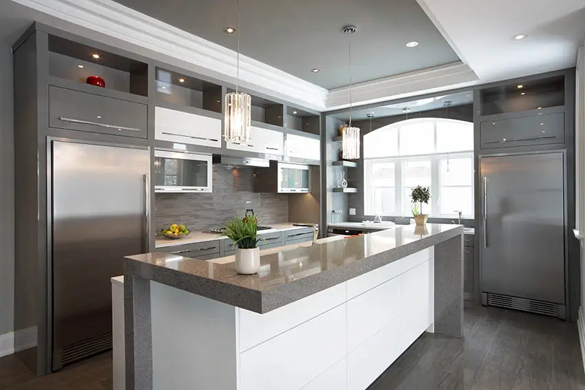 Modern kitchen with gray solid surface countertops white island gray cabinets