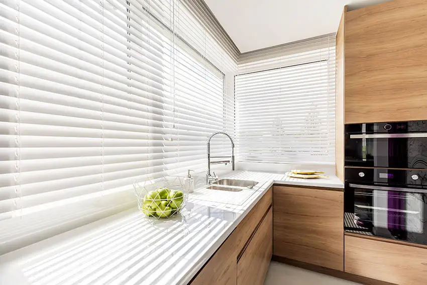 Modern kitchen with blinds in corner window