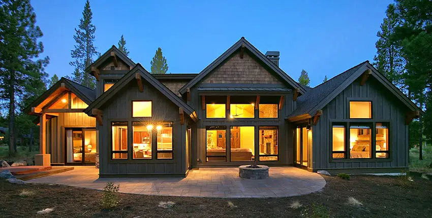 Mountain craftsman house backyard with concrete paver patio fire pit