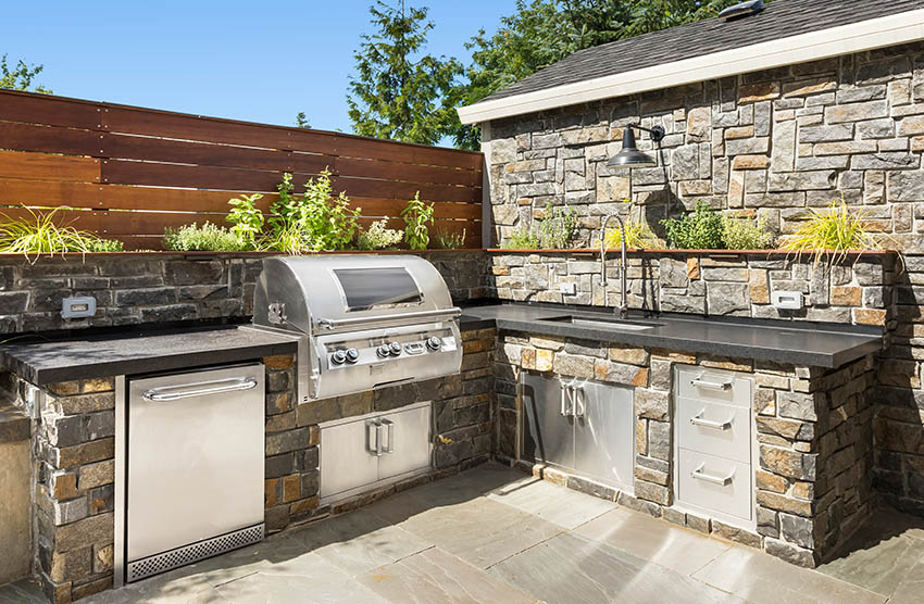Outdoor kitchen with sink and adjustable faucet