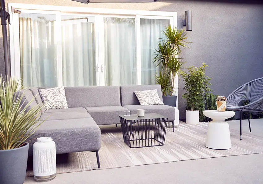 Outdoor sectional sofa with area rug and wire coffee table