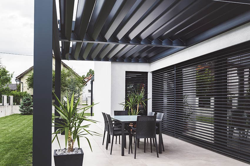Patio with outdoor blinds under pergola