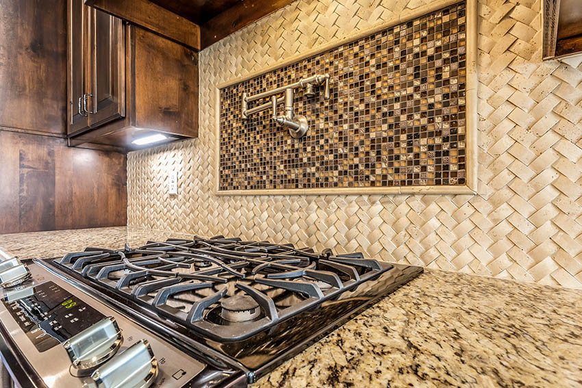 Pot filler faucet above cook top with basketweave mosaic backsplash