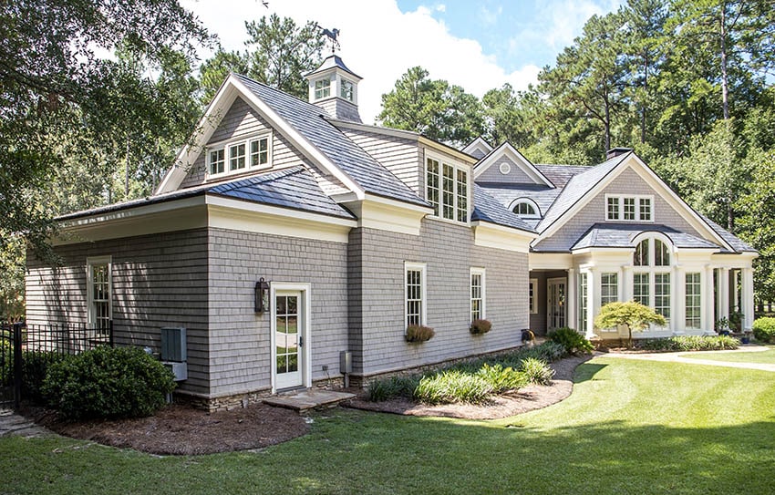 Shingle style house design with grey roof dormers
