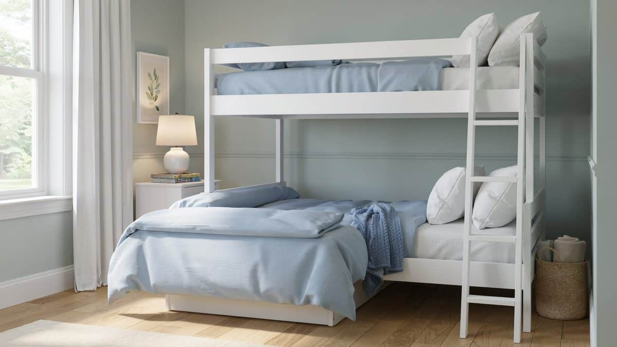 White twin over full bunk bed with ladder and blue bedding by a window