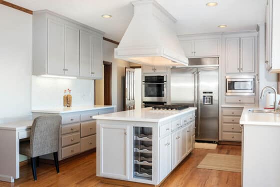 Corian Kitchen Countertops Pros Cons   U Shaped Kitchen With Corian Countertops Light Gray Cabinets Island With Cooktop Ss 561x374 