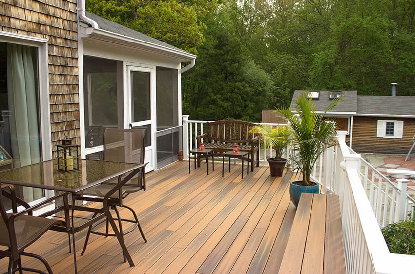Backyard raised wood deck with white railing