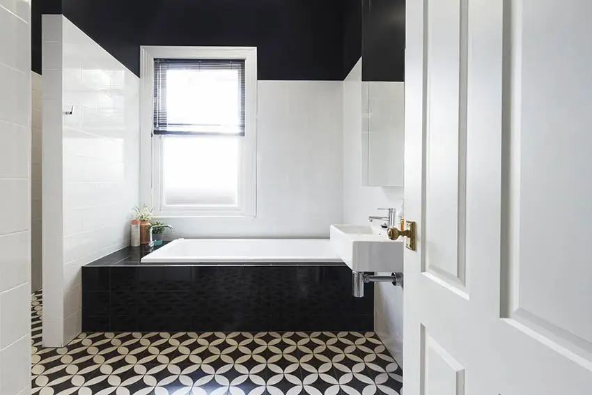 Bathroom with black and white vinyl flooring alcove tub