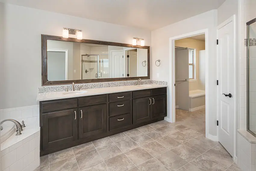 Bathroom with dual vanities and beige vinyl floor sheets