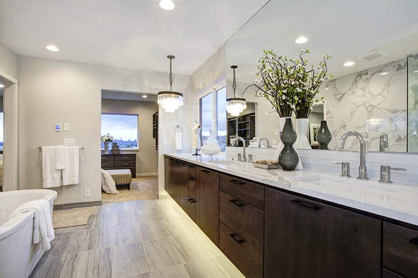 Bathroom with quartz countertop vanity with dual sinks under cabinet and pendant lights