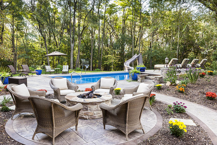 Circular stamped concrete patio with textured surface, walkway and pool deck