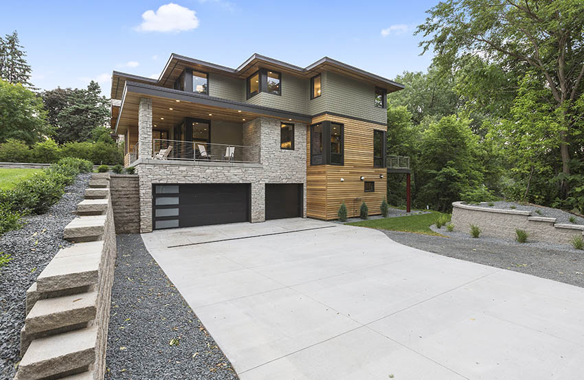 Contemporary house with concrete driveway gravel border