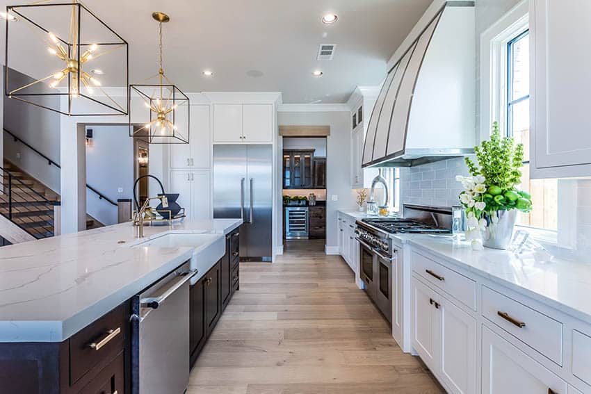 Contemporary kitchen with quartz countertops dark wood island white shaker cabinets