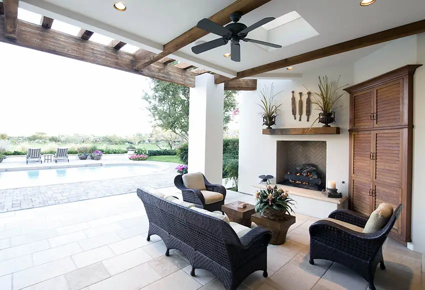Covered travertine patio with fireplace