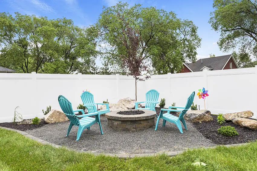 Gravel patio with teal polypropylene outdoor furniture