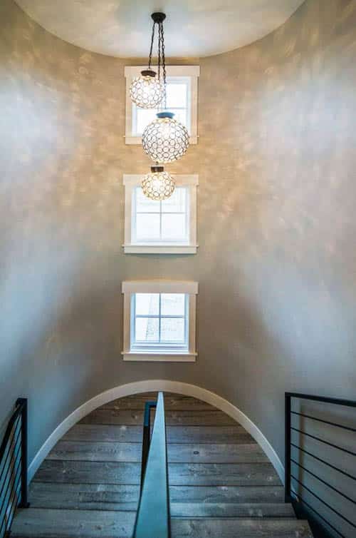 High ceiling staircase with globe lighting