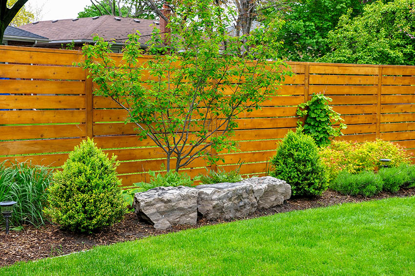 Horizontal wood slat garden fence