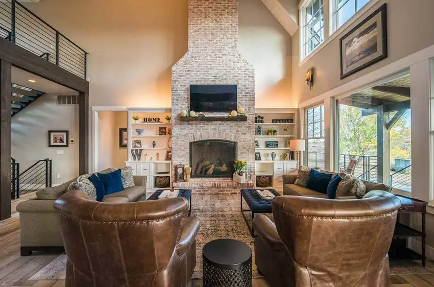 Large living room with brick fireplace leather furniture