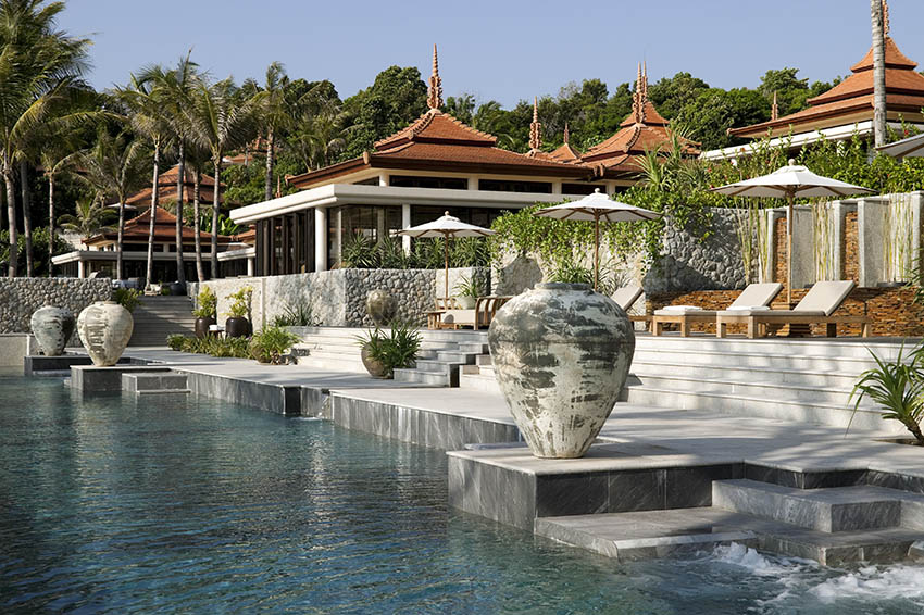 Luxury swimming pool with raised patio and stacked stone wall