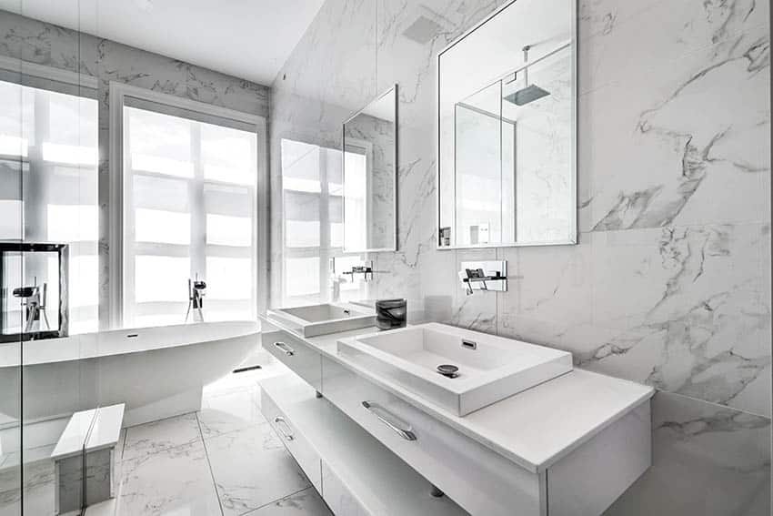 Marble bathroom with dual vanity and modern sink with chrome wall mounted faucets
