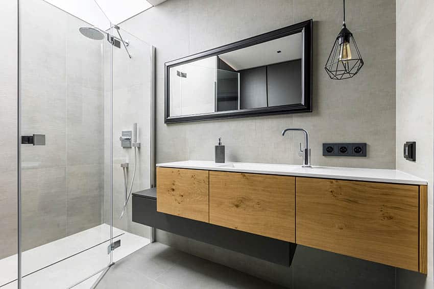 Modern bathroom with rain shower glass enclosure floating wood vanity
