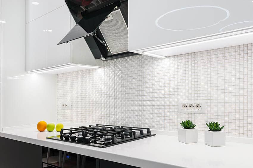 Modern kitchen with gas cooktop and mosaic tile backsplash
