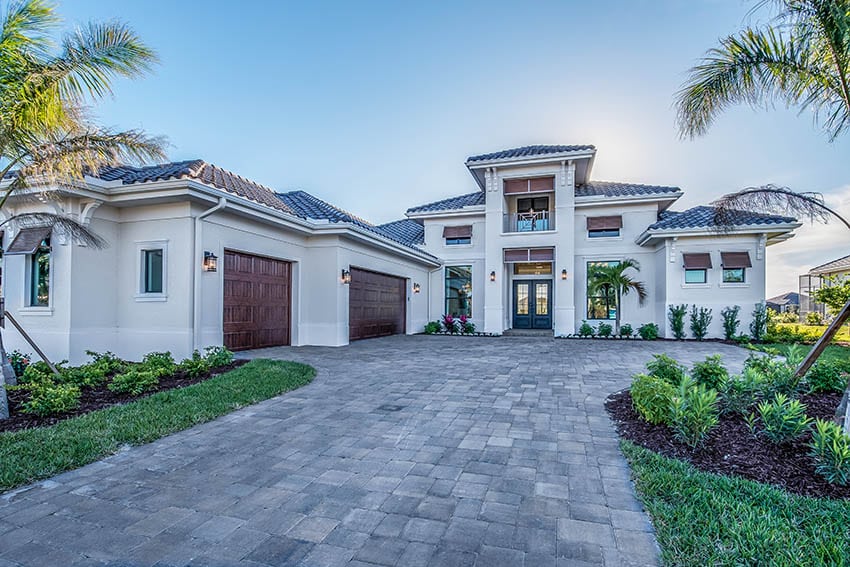 Paver driveway to luxury house with 3 car garage