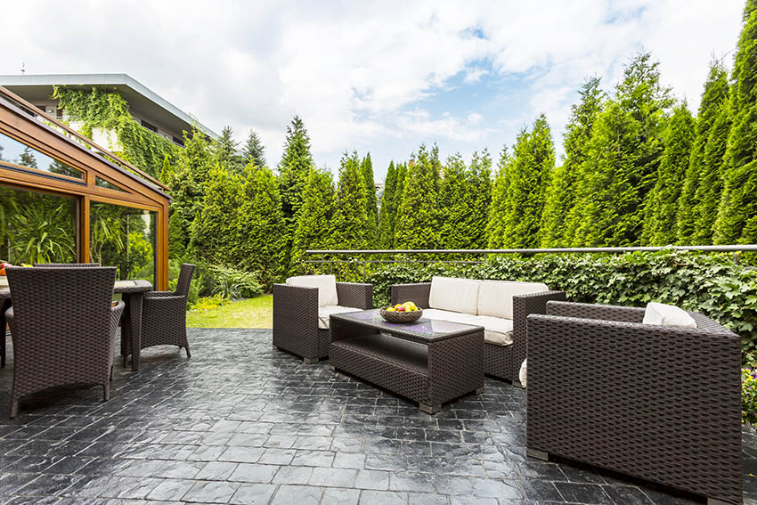 Raised black slate patio design with outdoor furniture