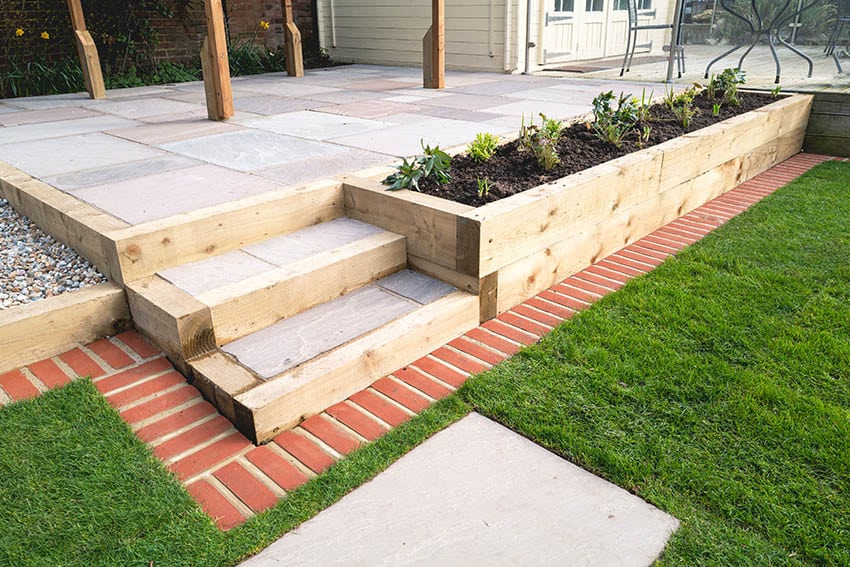 Raised concrete patio with wood planter boxes