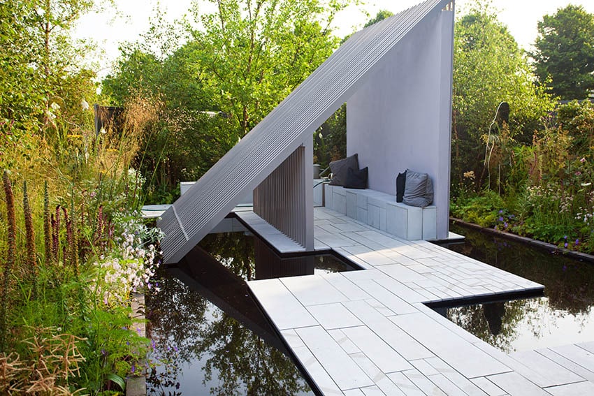 Raised patio design above water feature pond modern pavilion with sitting bench