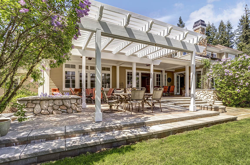 Raised patio with pergola and outdoor dining table