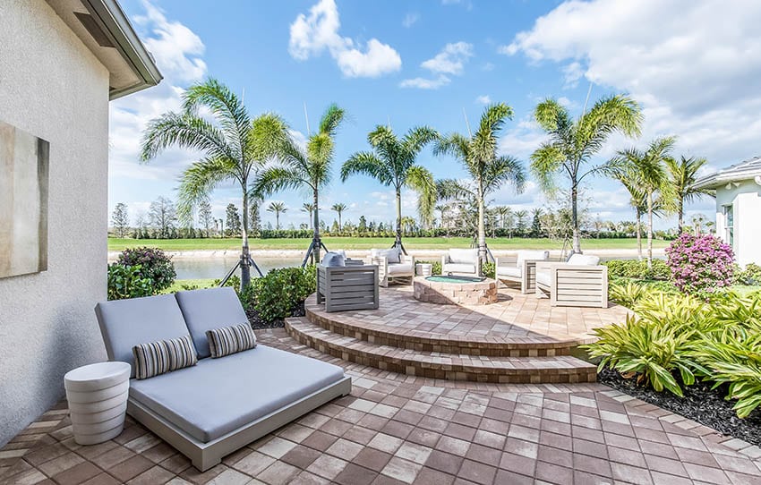 Raised paver patio with fire pit and water views