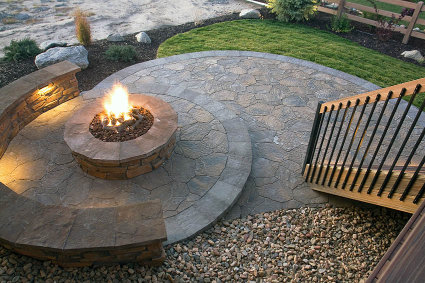 Raised stamped concrete fire pit with bench