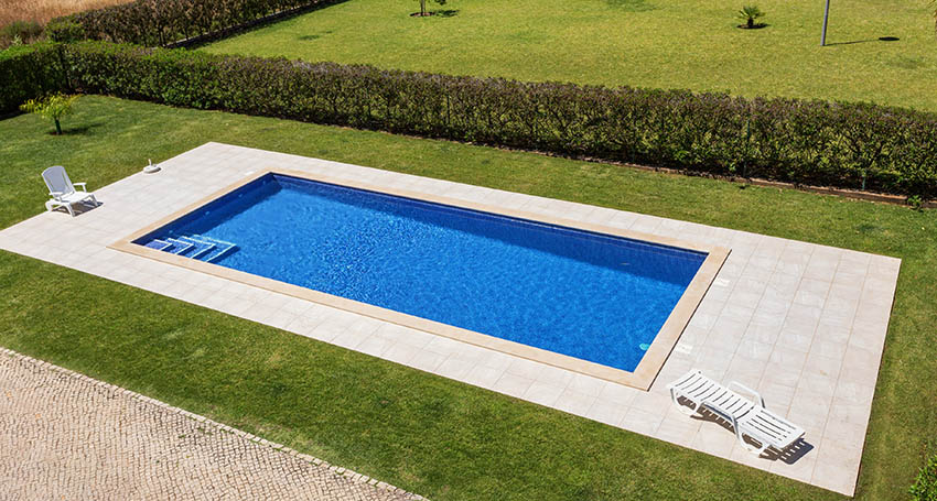 Rectangular swimming pool with concrete sun deck