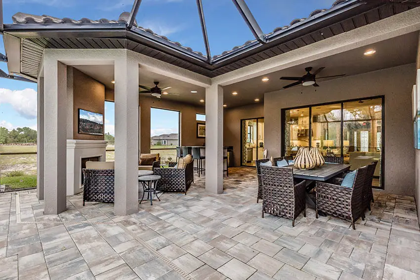 Silver travertine patio with outdoor fireplace and tv