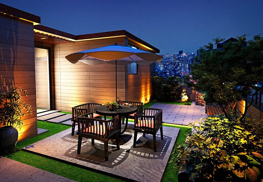 Small concrete raised patio above artificial turf with dining table