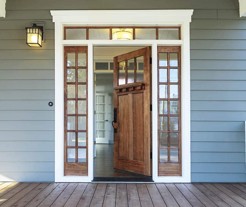 Wood door with white brickmold and sidelight windows