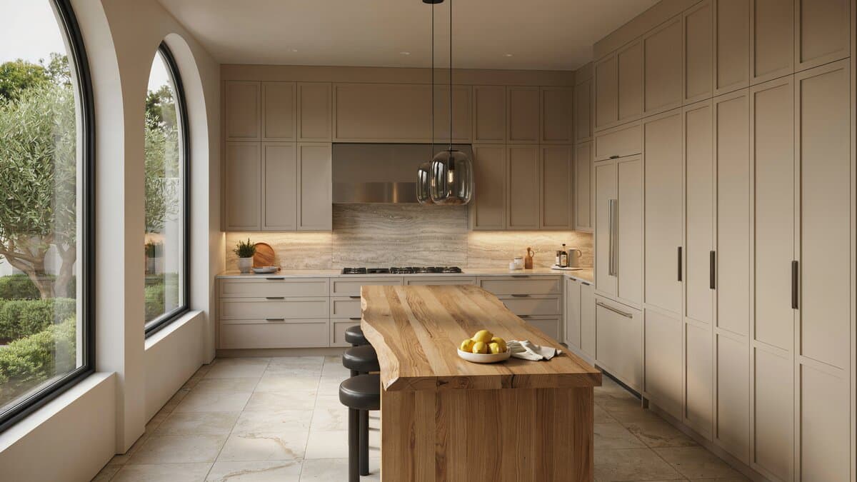 Neutral kitchen with wood-topped island and natural stone tile flooring near an arched window