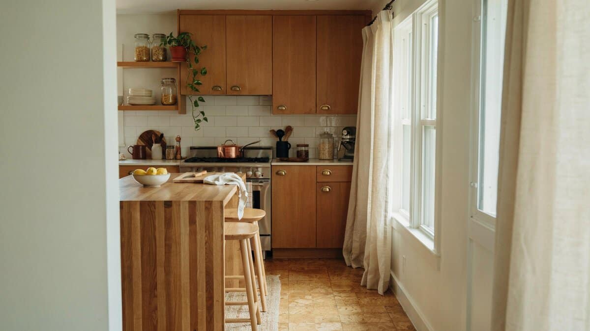 Warm wood kitchen with butcher-block island and cork flooring in cozy natural tones